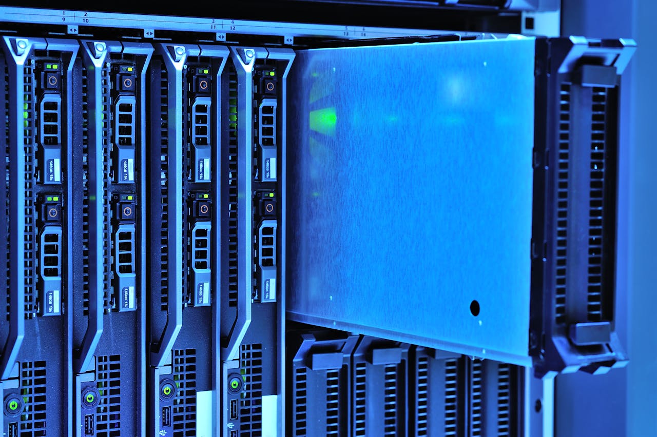 services-02 Detailed view of server racks with glowing lights in a data center environment.